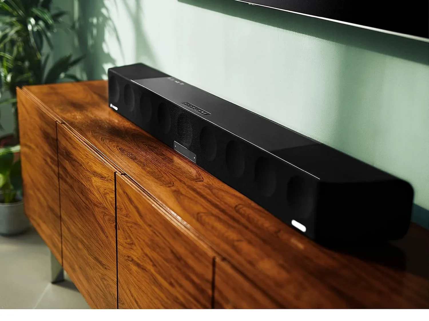 Sennheiser AMBEO Soundbar Max on a wooden sideboard