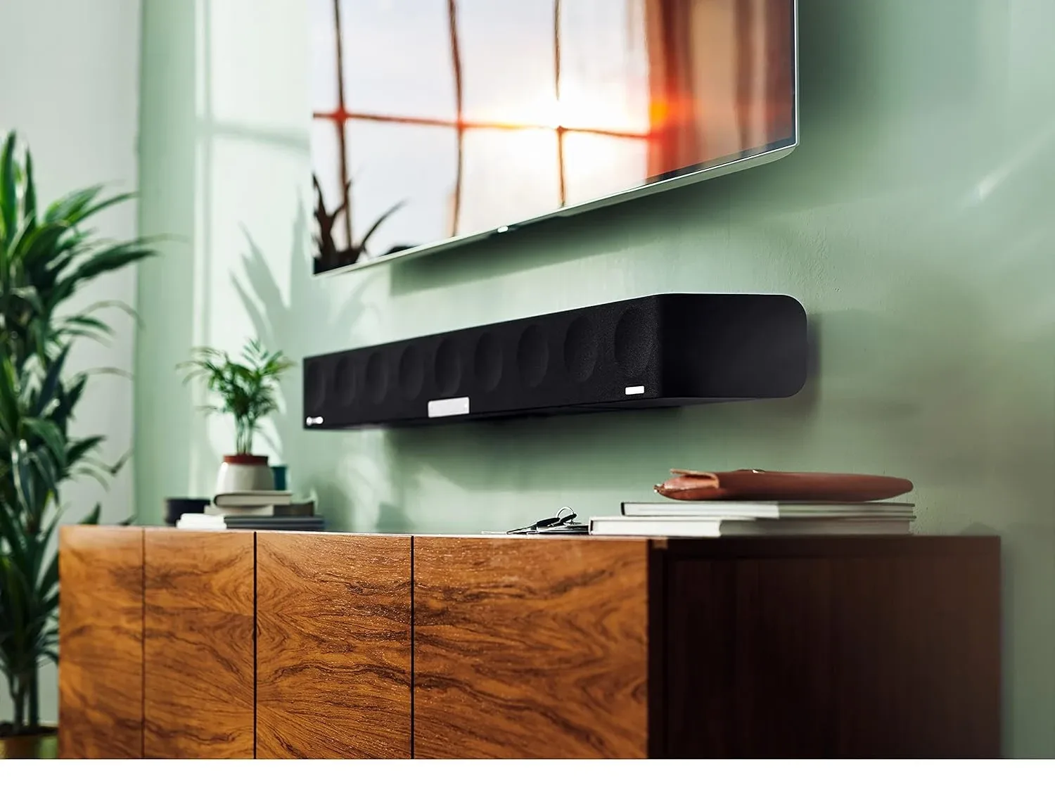 Sennheiser AMBEO Soundbar Max wall-mounted beneath a television