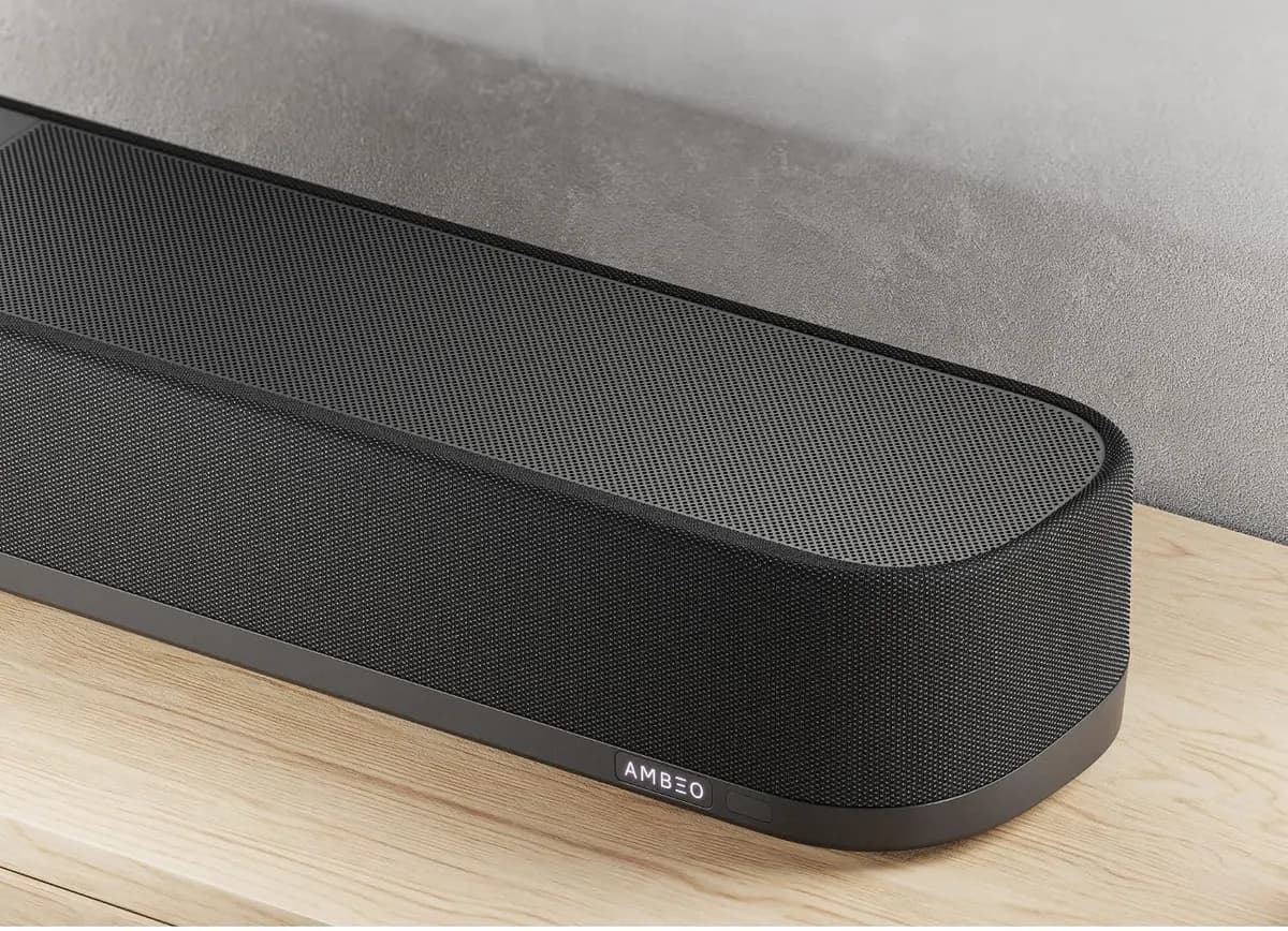 The end of the AMBEO Soundbar Plus resting on a wooden surface