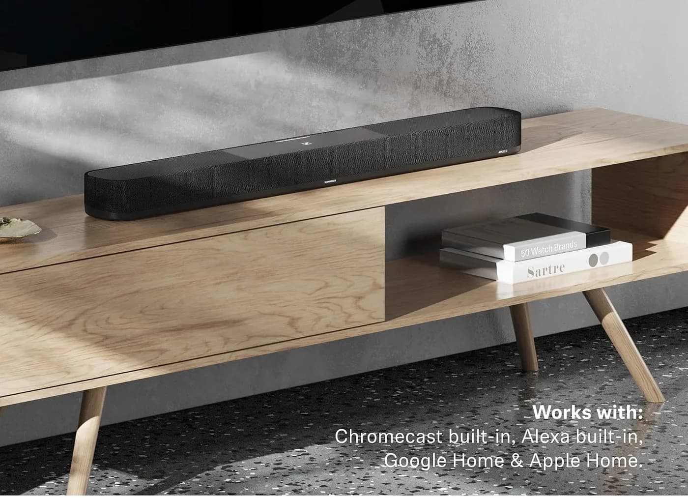 The AMBEO Soundbar Plus on a sideboard, listing its compatible smart-home ecosystems